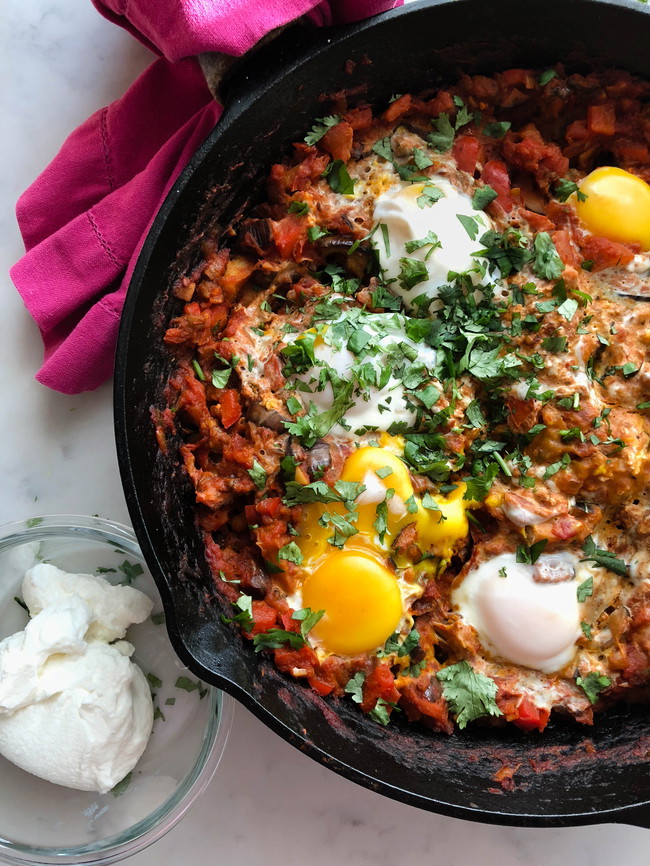 a pan of Shakshuka which is poached egg in spicy tomato sauce