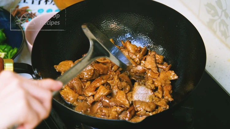 Image of Turn the heat to high and add the marinated pork. Stir for a few minutes or until the meat changes color. Remove the meat from the wok but leave the oil behind.