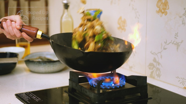 Image of Chef's Secret: During stir frying, Chinese chefs like to toss the wok over blazing heat and intentionally create dramatic flames. It's not just for show—it's a core part of achieving 
