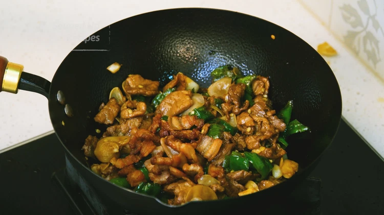 Image of Introduce the pork back to the wok and toss well. The cracklings should be added last so they stay crispy. Enjoy!