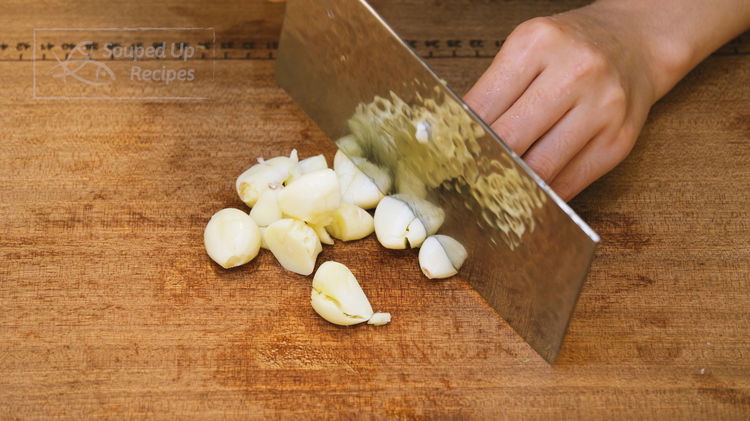 Image of Crush 10 cloves of garlic and peel. Then roughly dice...