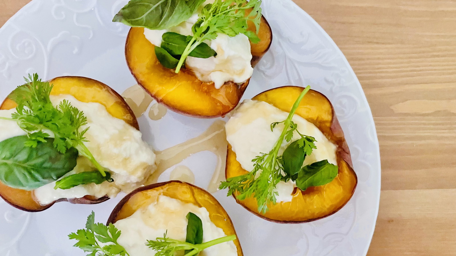 Peaches topped with ricotta, honey, and herbs