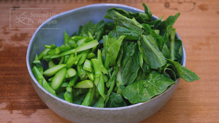 Image of Separate the leaves and stems, use the roll cutting technique to slice the stems into thin pieces, and chop the leaves smaller. Set them aside.