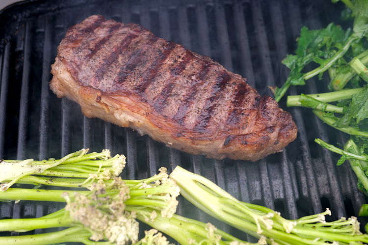 Image of Grill steak while sauce comes together