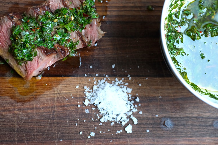 Image of Plate by spooning sauce over rested, grilled meat with more on the side
