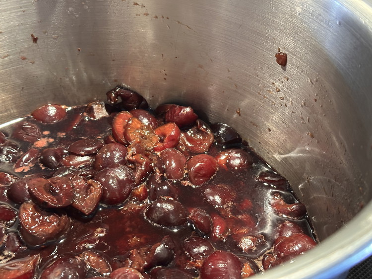 Image of Once thickened, fold in your 10 cups of cherries. They can be pitted, whole, or sliced, depending on your preference and intended use. Bring the cherries to a boil and reduce heat, simmering for 3-5 minutes.