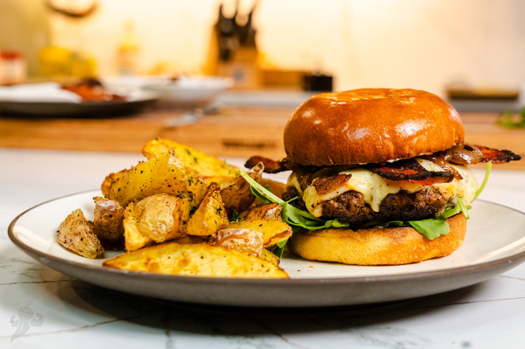 Image of It’s finally time to assemble the burger. I do this by starting with the bottom bun, add mayo, the arugula with the lemon juice, the burger patty with cheese, the bacon, and the caramalized onions, and the top of the...