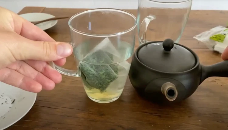 Image of Remove the tea bag and savor your gyokuro. The silk bag allows more expansion than a store-bought teabag, though not as much as a kyusu. For the best experience, use a kyusu teapot when possible.