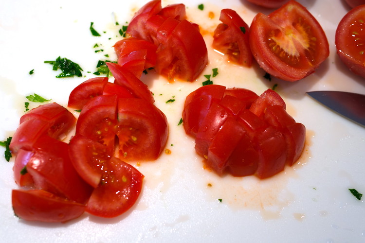 Image of Roughly chop your tomatoes.  Core the tip but do not deseed and keep the tomato water.  You want to retain the moisture from the vegetables to stew this dish.