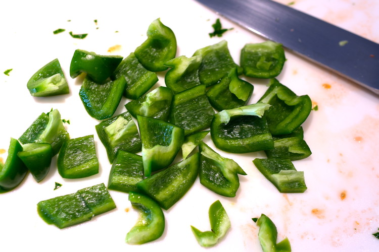Image of Core and chop the green bell pepper. You are looking for pieces that are about a half inch to an inch square
