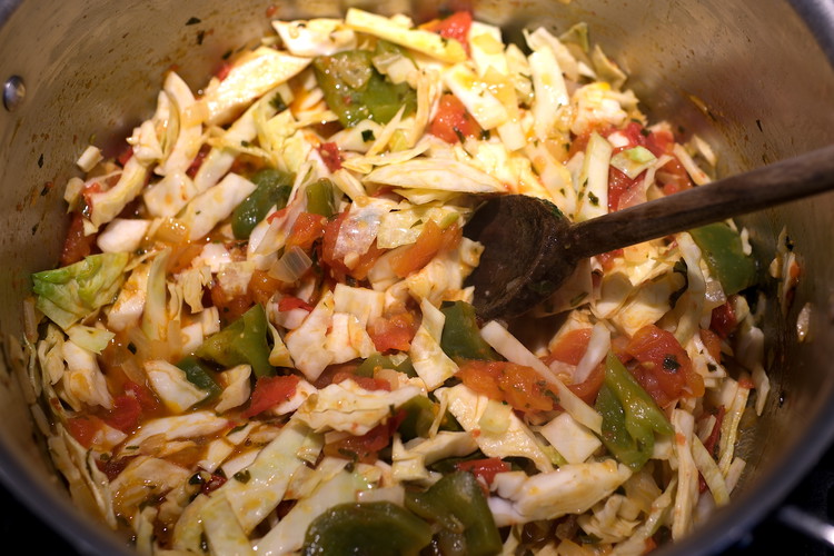 Image of Add the chopped cabbage to the tomato sauce.  Add the remaining ¼ teaspoon of salt and stir.  Cover and let cook a minute or two while you wrap the hot dogs