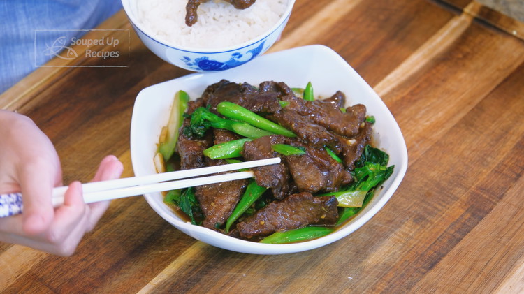Image of Introduce the beef back into the wok, pour in the sauce, and stir until the sauce is thickened. Serve with white rice.