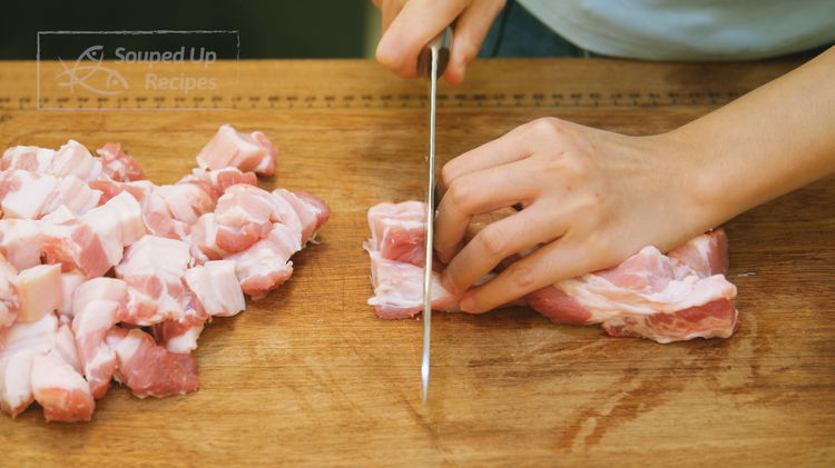 Image of Cut the skin-on pork belly into thumb-sized pieces. The skin...