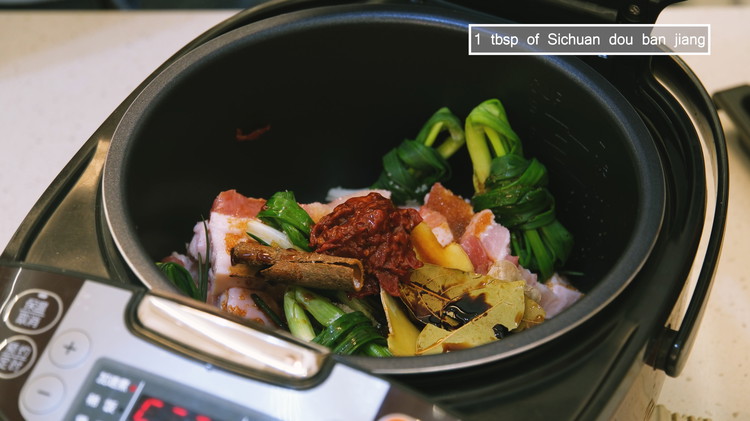 Image of Add the pork belly, scallions, garlic, ginger slices, cinnamon stick, bay leaves, sugar, Chinese cooking wine, soy sauce, dark soy sauce, and Sichuan dou ban jiang. If you don't eat spicy food, replace the Sichuan dou ban jiang with 1...