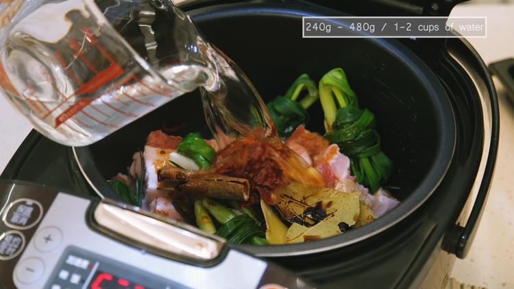 Image of Add 1–2 cups of water and stir well. The liquid should sit just below the ingredients because the rice cooker's heat is generally low. Too much water will slow down the sauce from thickening.