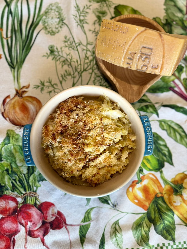 Picture of a cabbage in a blue bowl with toasted breadcrumbs and parmesan on top