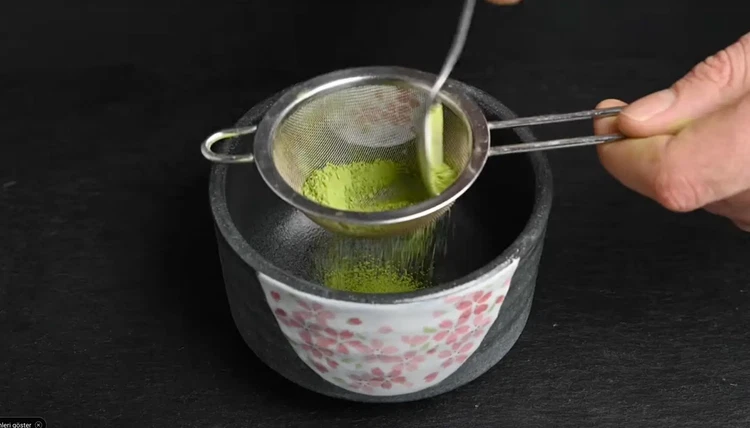 Image of Gently sift the powder to remove clumps. This ensures a smooth, frothy texture when whisked.