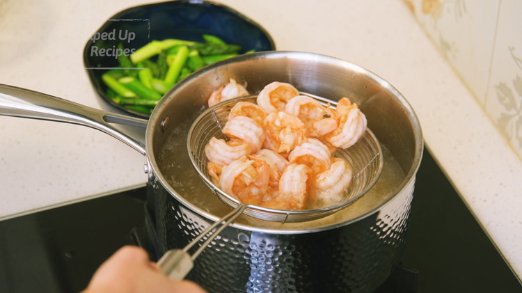 Image of Add the marinated shrimp to the boiling water and blanch for 1 - 1.5 minutes, depending on the size of your shrimp. Remove the shrimp from the water and drain thoroughly.