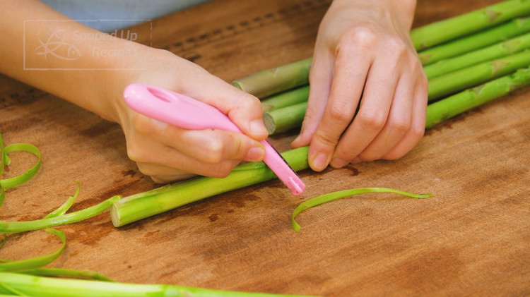 Image of Snap 1 inch from the end of one asparagus to see if it is stringy and fibrous. If so, use a peeler to peel the bottom part of the asparagus skin. This improves your eating experience because I hate pulling...