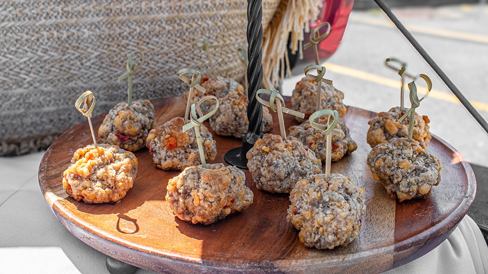 a pimento cheese ball on a wooden plate