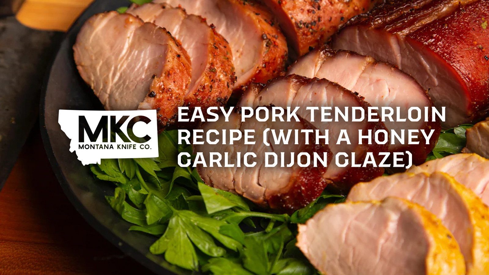 Glazed pork tenderloin with honey and Dijon, resting on fresh rosemary and thyme.