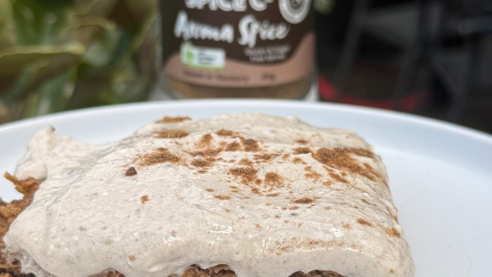 carrot cake recipe with yoghurt topping next to glass jar of Secret Spice Co Aroma blend