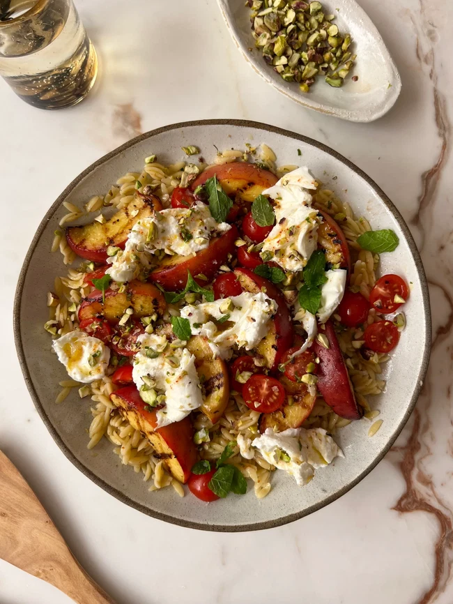 Image of Grilled Peach Burrata Salad with an Aleppo Chili Vinaigrette
