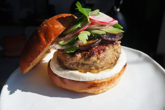 Image of Shawarma Spiced Burger, Yogurt Tahini, Eggplant & A Radish Parsley Salad