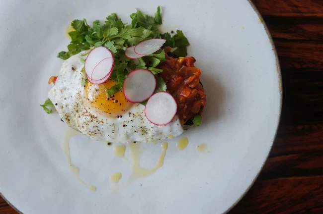 Image of Curried Tomato Jam Toast with A Fried Egg, Mustard Seeds & Cilantro
