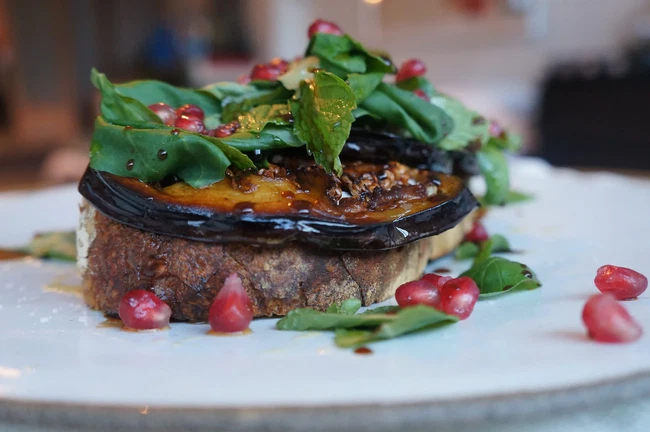 Image of Grilled Sourdough with Greek Yogurt, Pickled Eggplant, Pomegranate & Fresh herbs