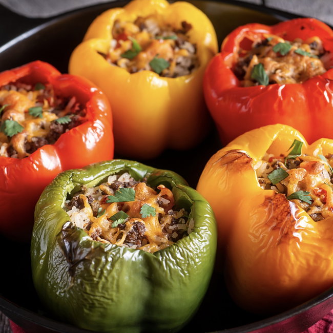 Image of cuban stuffed peppers with picadillo + saffron rice