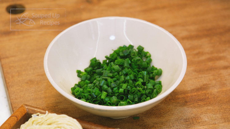 Image of Cut the scallions in half. Dice the green tops and reserve them to sprinkle at the end. 
