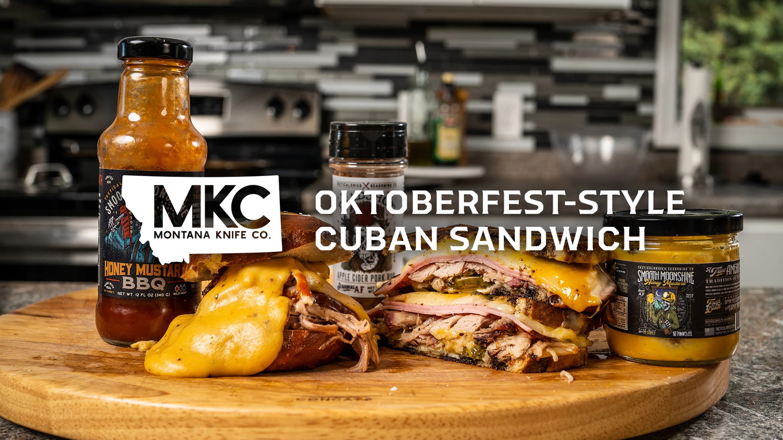 Cuban sandwich with pork, cheese, pickles, and mustard on a wood board, with Honey Mustard BBQ and Smooth Moonshine.