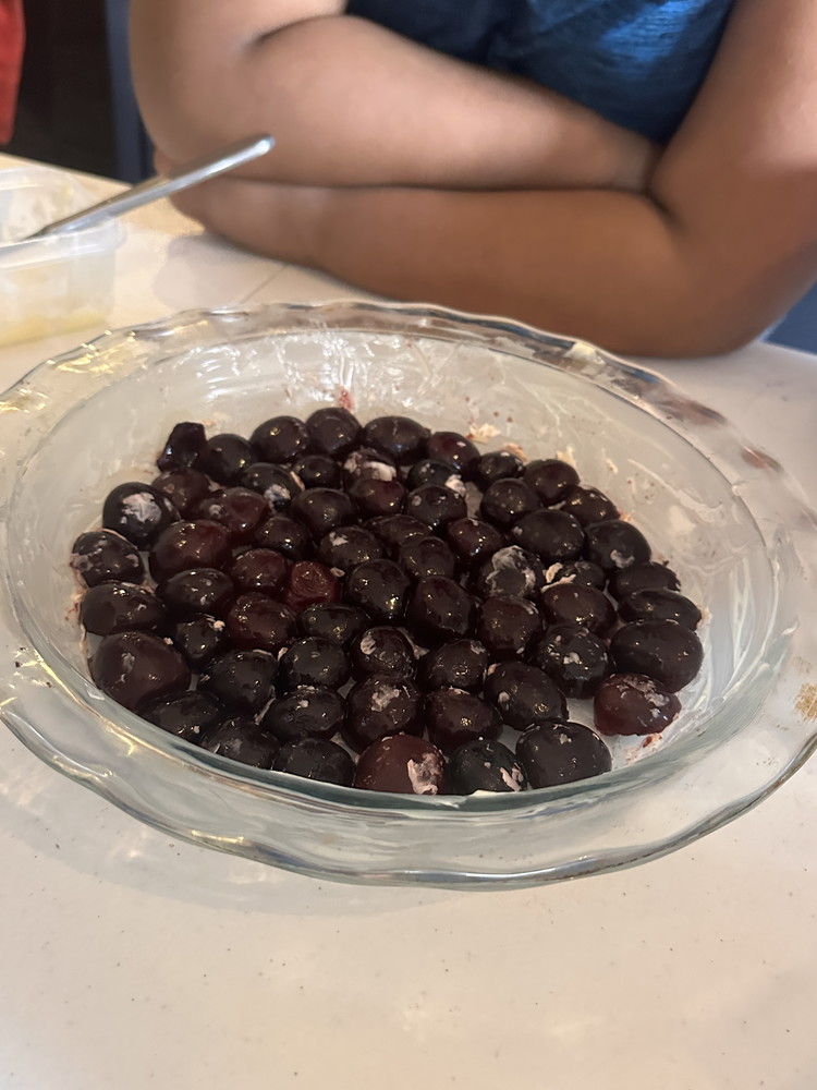 Image of Spread your cherries across the bottom of your greased pan.