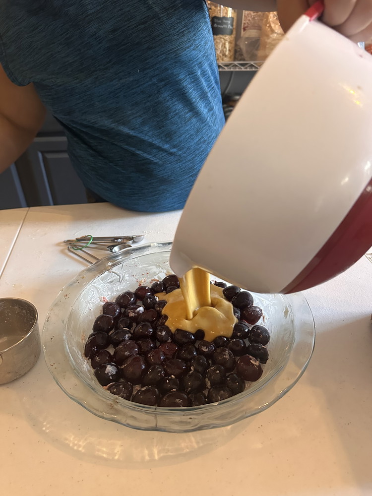 Image of Pour the batter into your pie pan over the cherries.