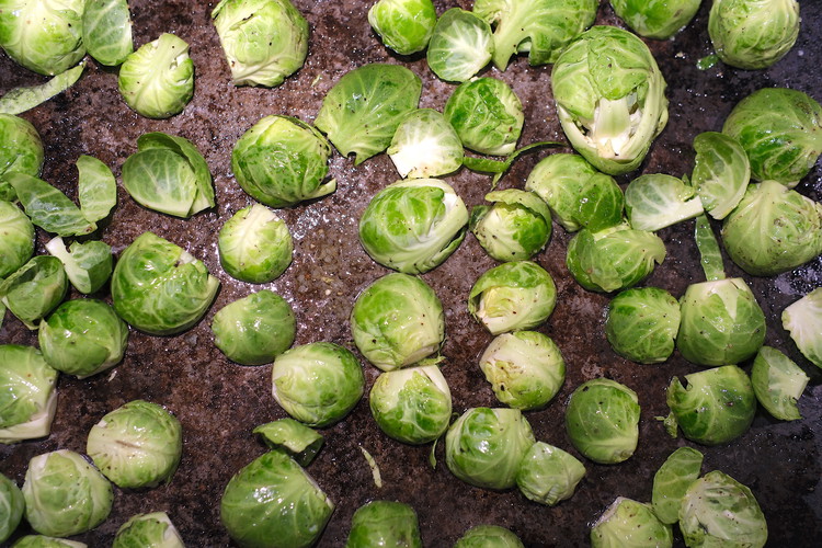Image of Toss brussels sprouts with olive oil and salt and arrange them on a steel/heavy baking sheet face down.  For a better crisp/roast do not crowd the sheet (crowded brussels will steam)