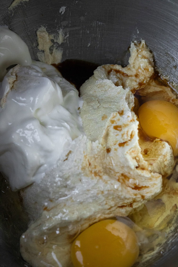 Image of Add in zest, eggs and mix well. Add in yogurt...