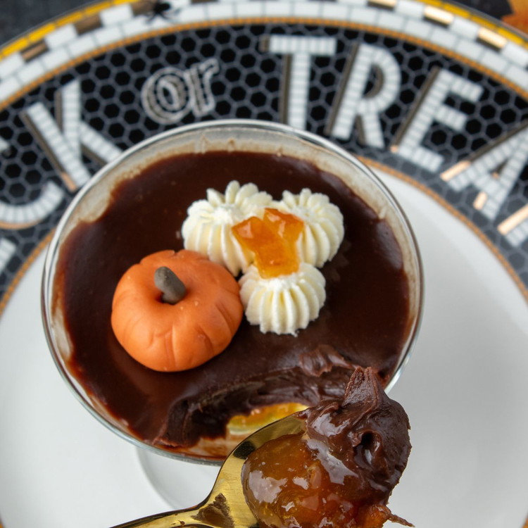 Image of Pick out long pieces of candied orange peel from the extra
marmalade and snip into tiny pieces to add to the top of the cream along with a
fondant pumpkin.