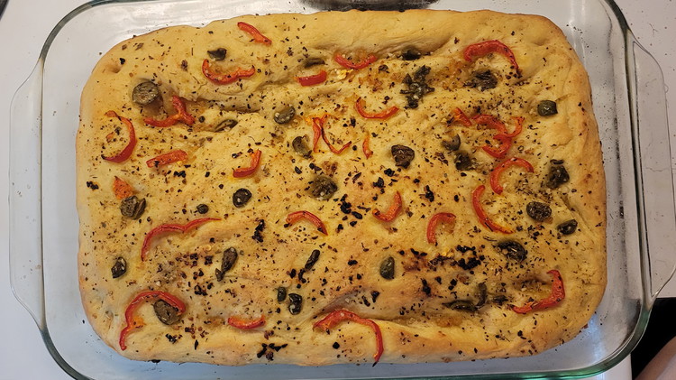 Image of Top & Bake: Preheat the oven to 400°F (205°C). Dimple the dough surface with your fingers to create small pockets. Sprinkle with flaky sea salt, dried basil and oregano, and add your chosen toppings if desired. Bake for 25–30 minutes...