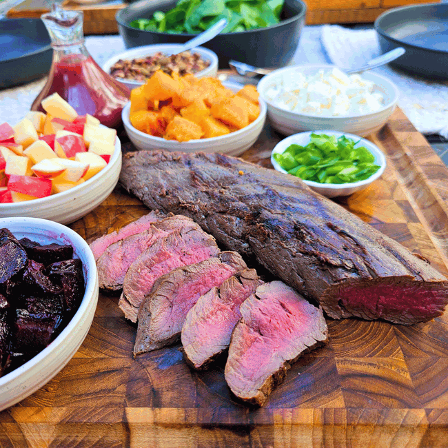 sliced elk tenderloin on board
