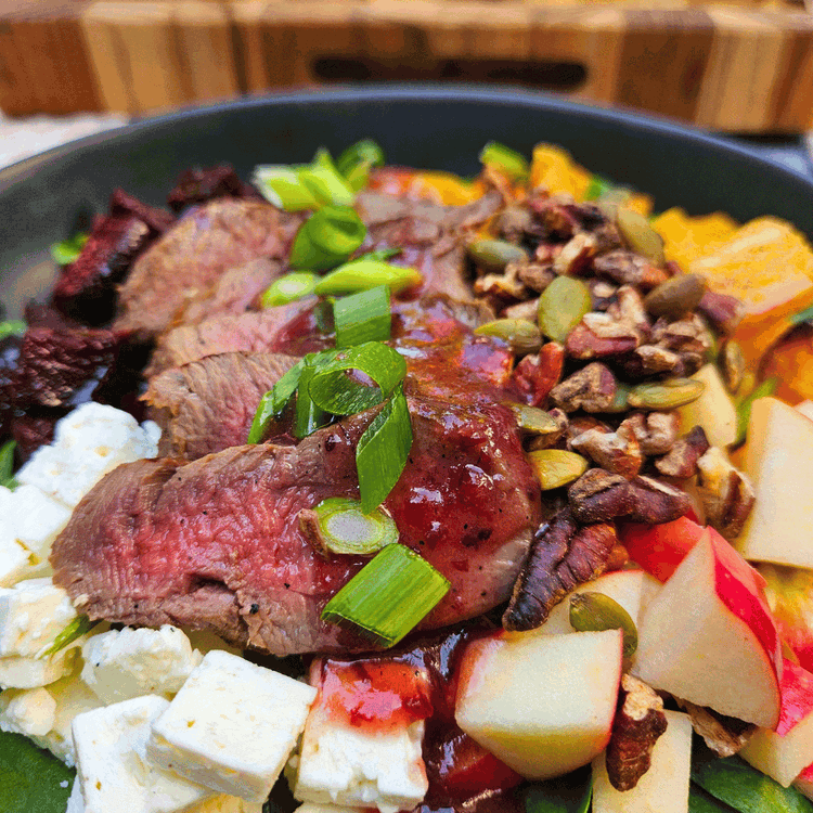 Image of Top with sliced tenderloin and drizzle on the dressing. Top with sliced green onions.