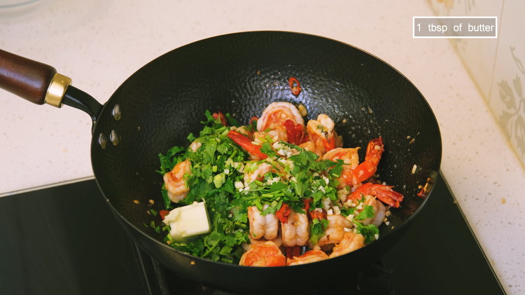Image of When the shrimp turn pink, add the cilantro, the rest of the diced garlic,  butter, and some salt to taste. Toss thoroughly and serve with white rice or plain noodles.