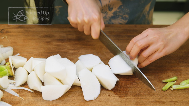 Image of About 40 minutes before the beef is ready, peel your daikon radish and cut it into big chunks. If you don't have daikon radish, carrots make a great substitute.