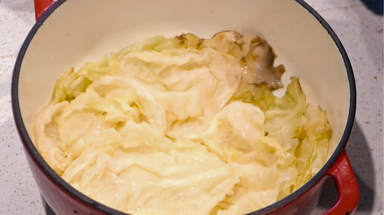 Image of Line the bottom of a large heavy-based pot with the spare cabbage leaves.