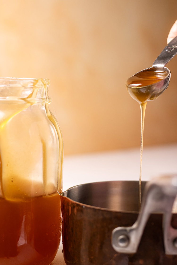 Image of In another bowl, measure out honey and butter.