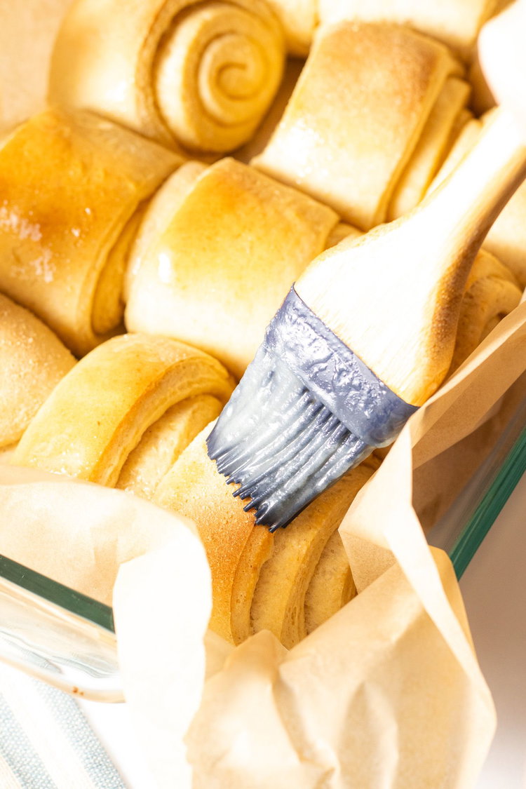 Image of Place rolls into a 9x13 baking dish. Brush with remaining...