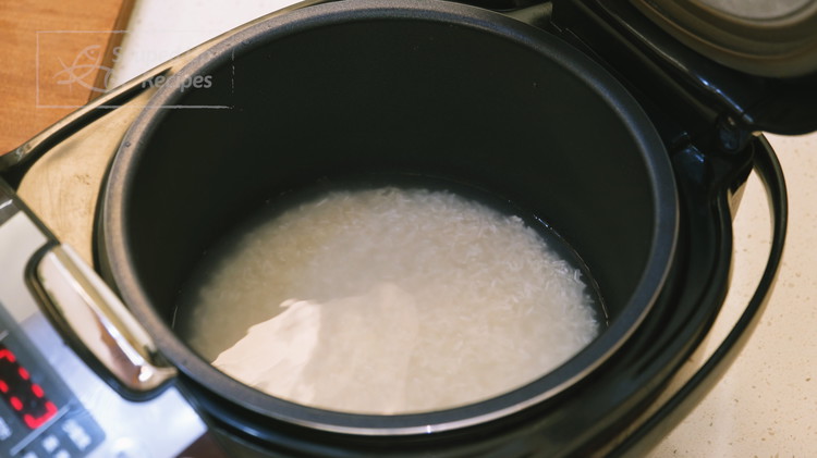Image of Rinse one cup of rice a couple of times and drain well. Add 1.5 cups of water and place the pot into the rice cooker and let it cook while we are prepping the rest of the ingredients. If you...