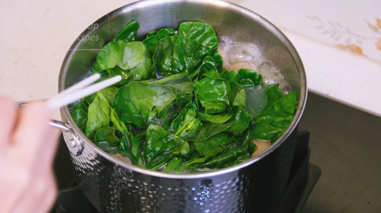 Image of Once the noodles are cooked to al denta, add all of the gailan (Chinese broccoli) leaves and cook for 10 more seconds.