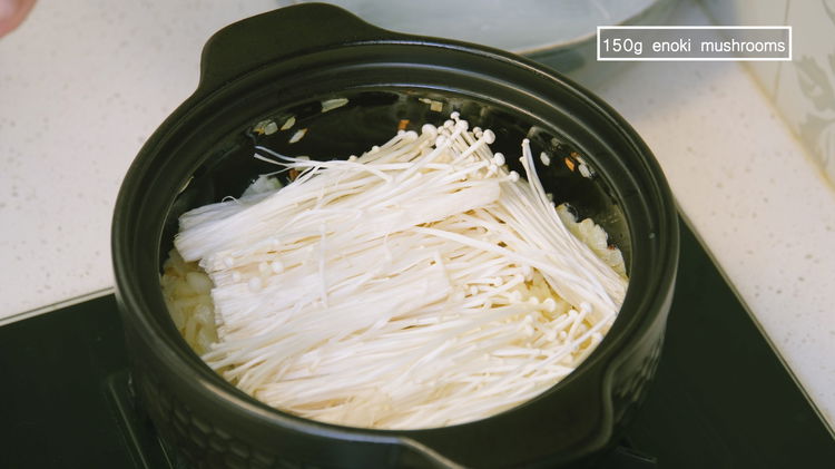 Image of Add the enoki mushrooms and spread them evenly on the...