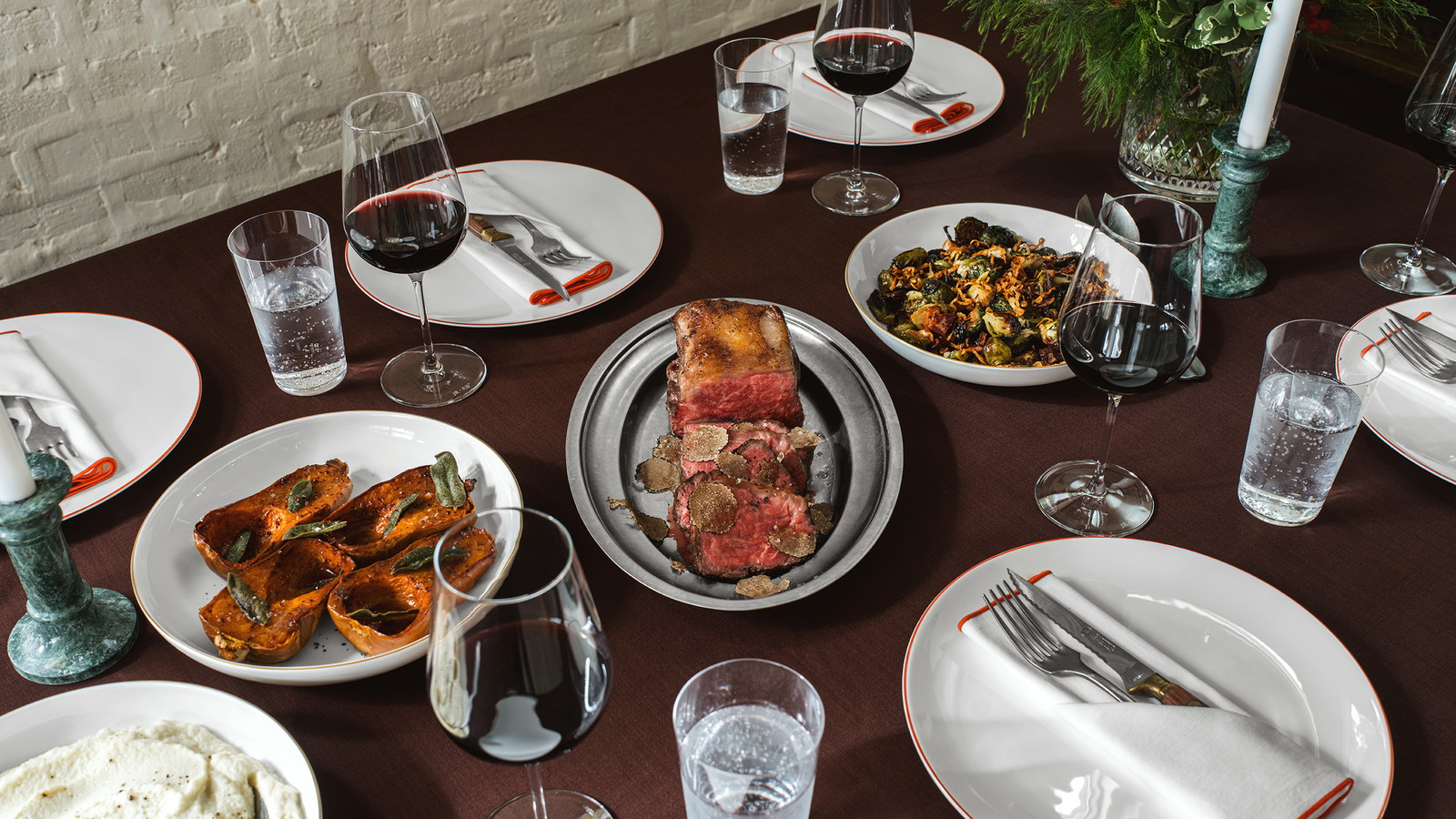 Manhattan roast on a dining table with sides and place settings